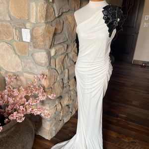 Badgley Mischka one shoulder evening gown white with black accent and leg slit.